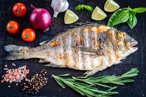 Grilled dorada fish fresh vegetables and herbs